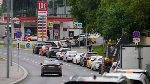Cars line up at a Lukoil gas station in Moscow during Russia's fuel rationing crisis