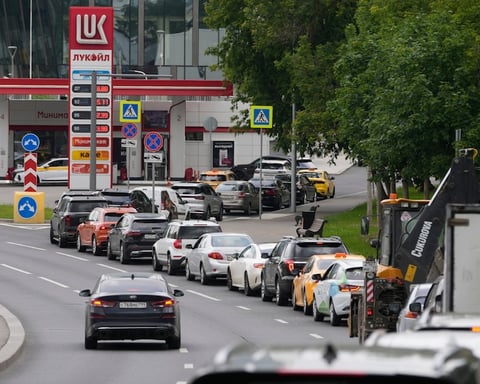 Cars line up at a Lukoil gas station in Moscow during Russia's fuel rationing crisis