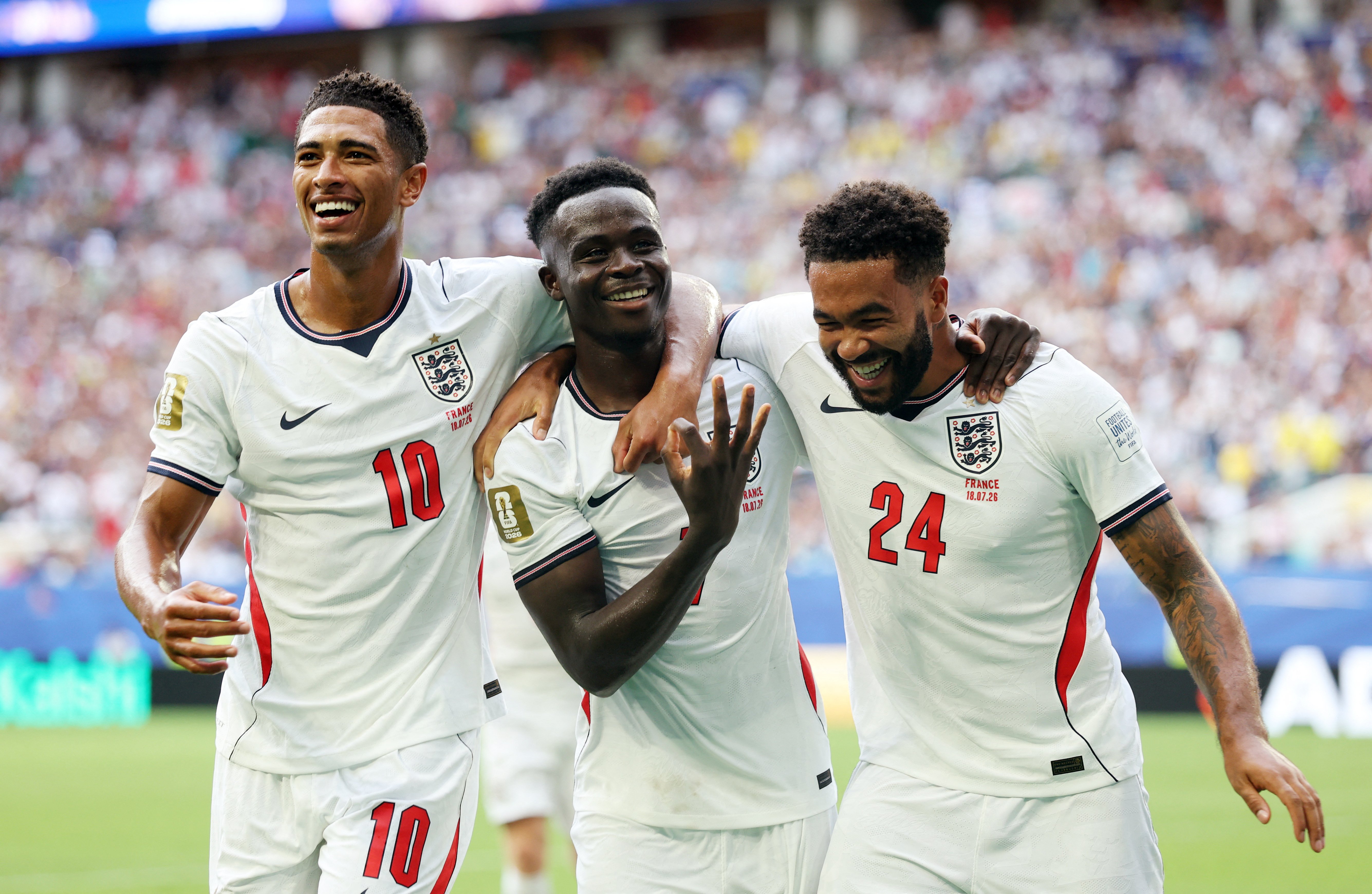 Bukayo Saka celebrates after completing his hat-trick with Jude Bellingham and Reece James during England's 6-4 win over France