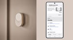The Samsung SmartThings app open on a Galaxy phone beside a connected smart-home device