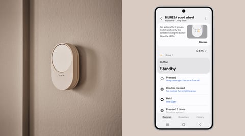 The Samsung SmartThings app open on a Galaxy phone beside a connected smart-home device