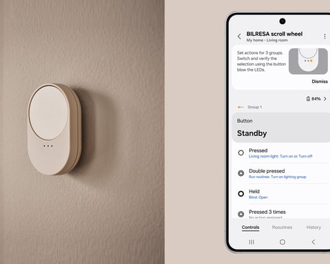 The Samsung SmartThings app open on a Galaxy phone beside a connected smart-home device