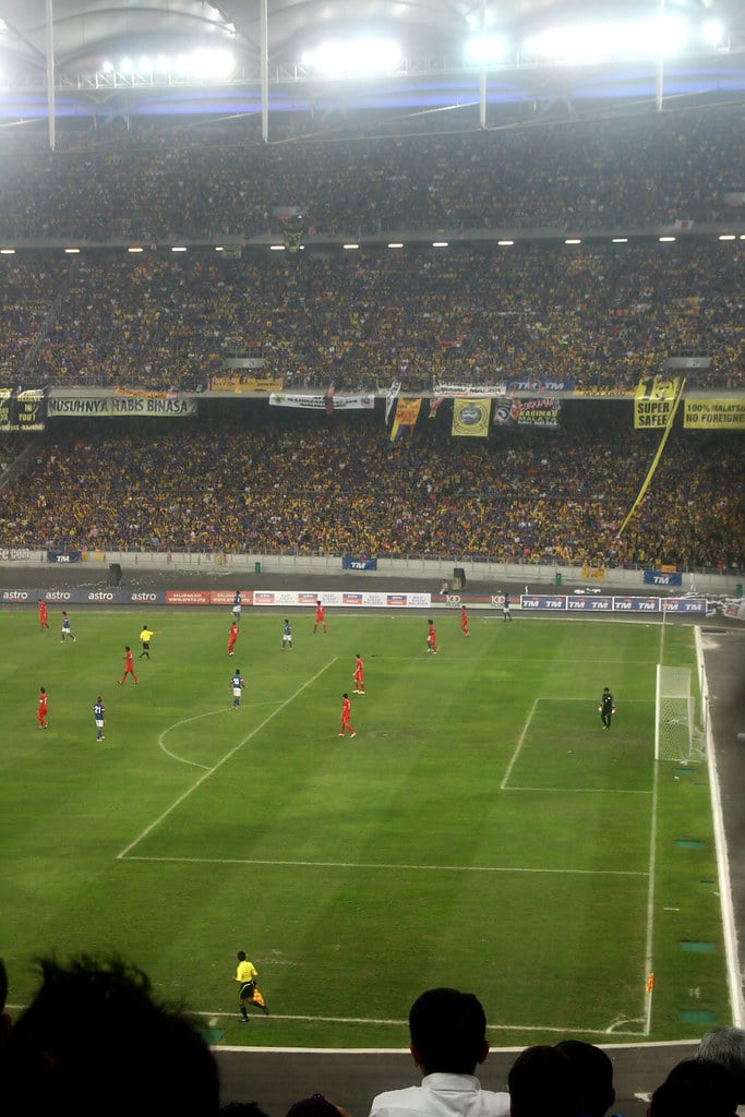 Singapore football fans and players at a stadium during international match