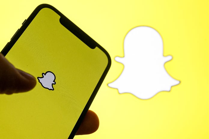 Snapchat app interface showing Snap Map with the new Now Playing music feature powered by Spotify, displaying a friend's current track in real time