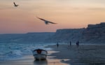 Fishermen on the beach at dusk in Eyl, Puntland, Somalia, the historic base of Somali pirate operations