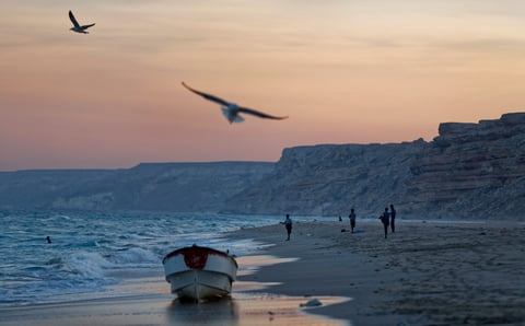 Fishermen on the beach at dusk in Eyl, Puntland, Somalia, the historic base of Somali pirate operations