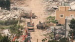 Israeli military equipment amid destroyed buildings in Mais al-Jabal village southern Lebanon April 2026