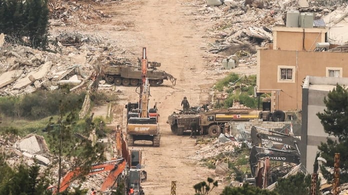 Israeli military equipment amid destroyed buildings in Mais al-Jabal village southern Lebanon April 2026