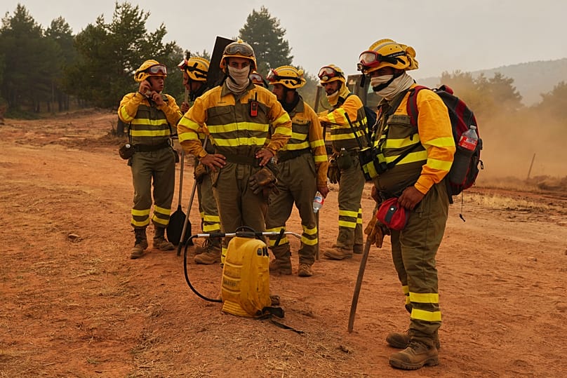 Forest rangers take a break during firefighting operations near Condemios de Arriba in Guadalajara province Spain