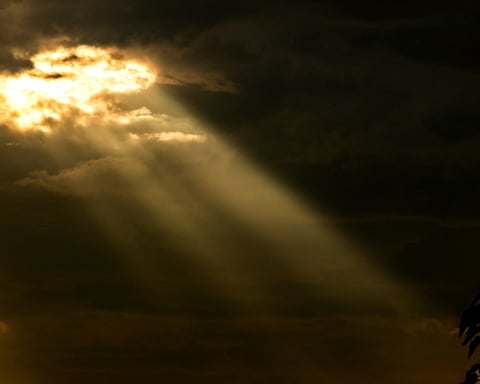 Storm clouds over a city skyline representing the stablecoin market cap decline of $10 billion since May 2026