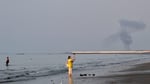 A plume of smoke rises over the Strait of Hormuz following an explosion off Bandar Abbas Iran July 2026
