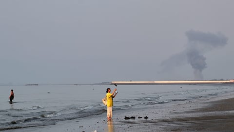 A plume of smoke rises over the Strait of Hormuz following an explosion off Bandar Abbas Iran July 2026