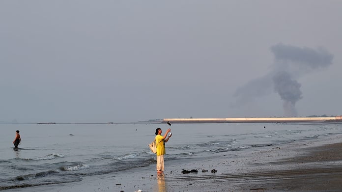 A plume of smoke rises over the Strait of Hormuz following an explosion off Bandar Abbas Iran July 2026