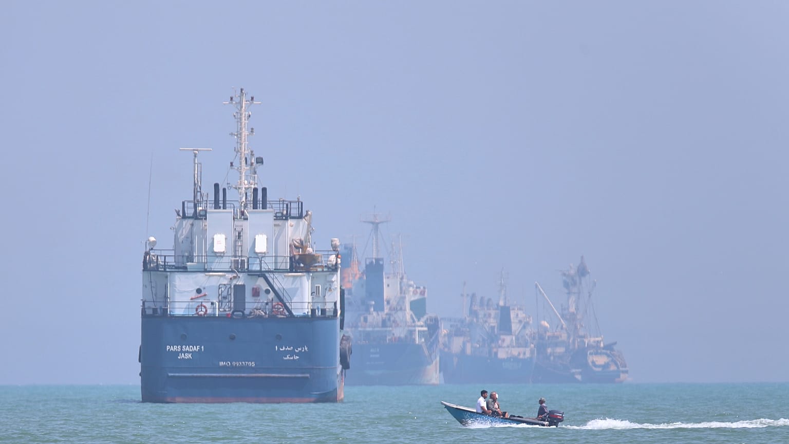 Commercial vessels navigating the Strait of Hormuz as Iran-US tensions escalate over Gulf ceasefire timing