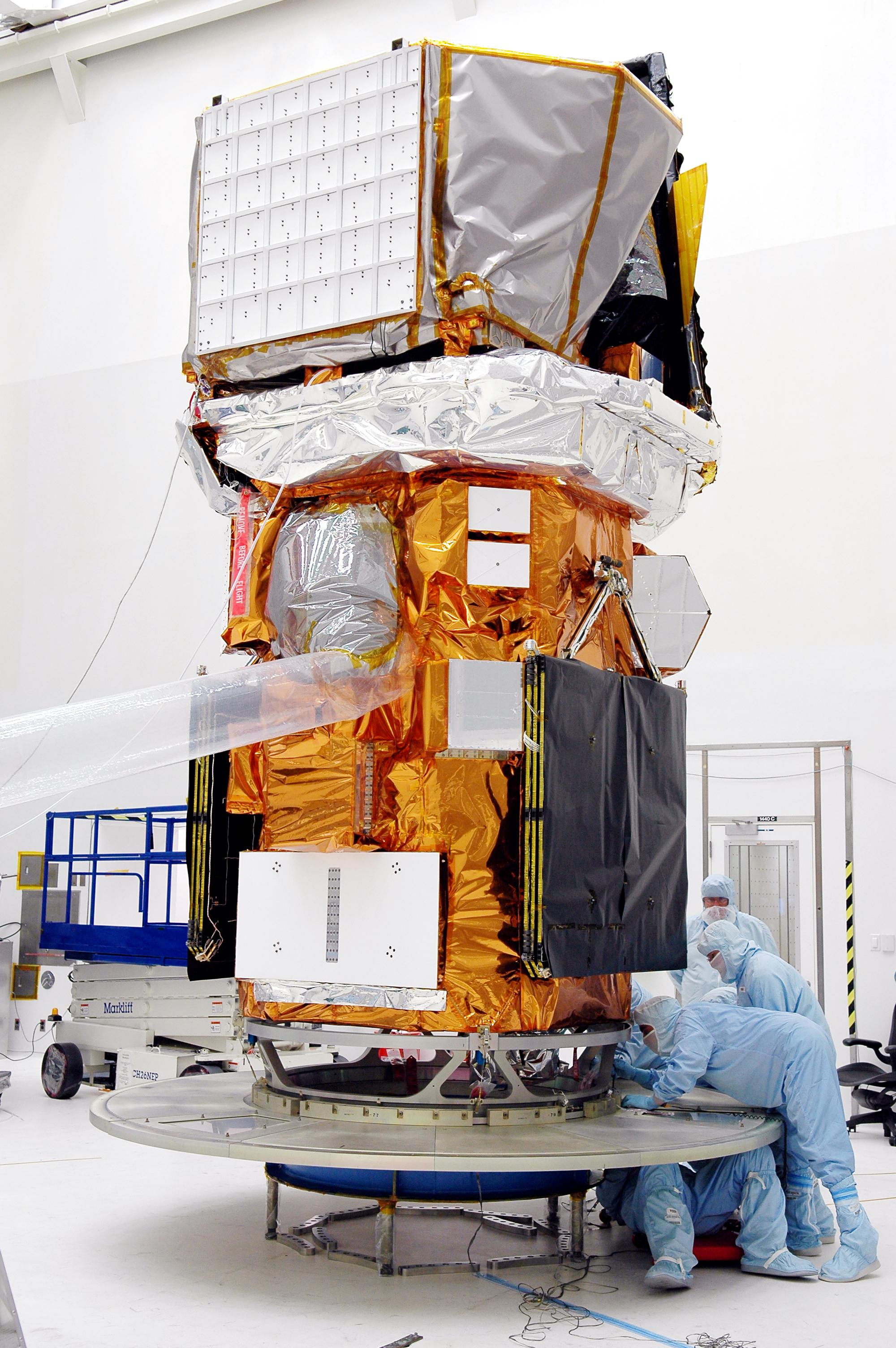 Technicians prepare the Neil Gehrels Swift Observatory spacecraft before its 2004 launch at Cape Canaveral