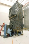 NASA technicians remove protective cover from Swift Observatory solar array at Cape Canaveral in 2004