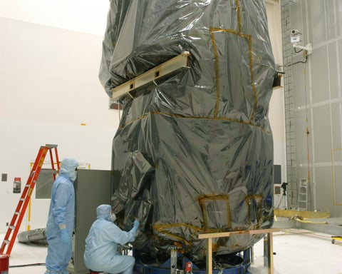NASA technicians remove protective cover from Swift Observatory solar array at Cape Canaveral in 2004