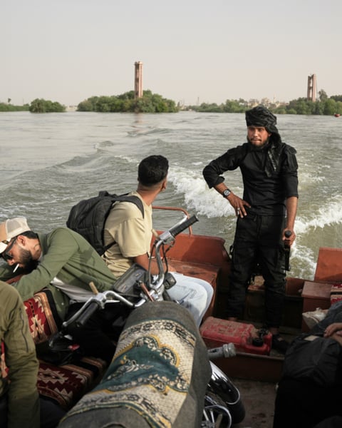 Residents travel by boat along the flooded Euphrates River near Deir Ezzor Syria where a ferry accident killed two children