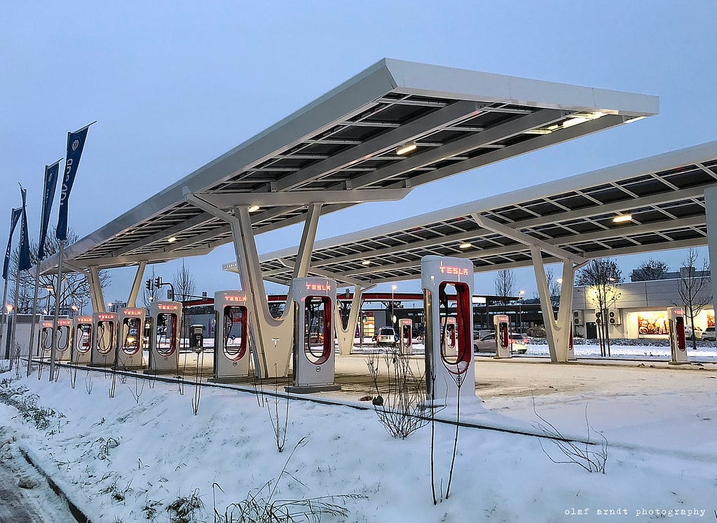 Tesla Supercharger station as the company invests billions in AI and robotics