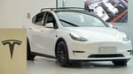A white Tesla vehicle on a road, representing the NTSB and NHTSA investigation into Tesla Full Self-Driving crashes