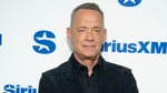 Tom Hanks in a baseball cap at a 2027 film event for The Comebacker