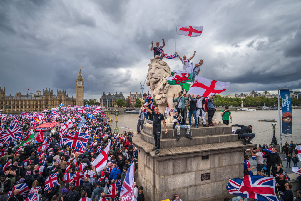 Protesters wave Union Jack and St George flags at anti-immigration rally in London amid Musk amplification controversy