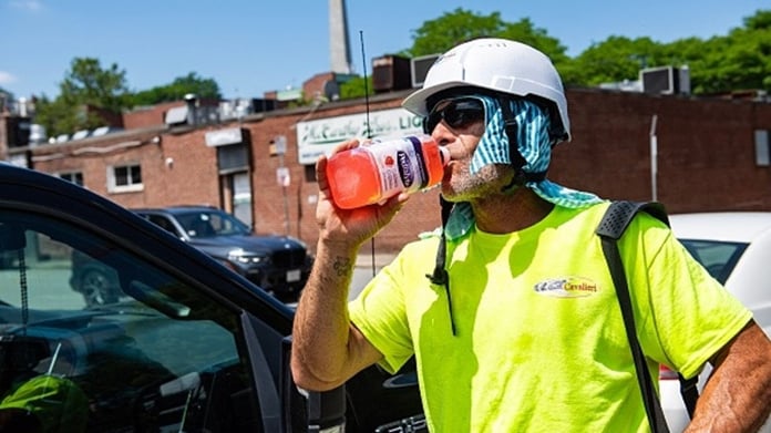 A construction worker takes a water break during the extreme heat wave in Boston July 2026