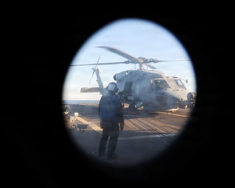 US Navy guided-missile destroyer USS Roosevelt and an HSM-79 helicopter conduct a Strait of Hormuz transit