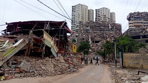 Rescue workers search through earthquake rubble in La Guaira Venezuela