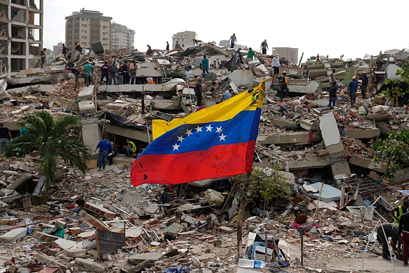 Rescue workers search through earthquake rubble in Venezuela following the June 24 twin earthquakes