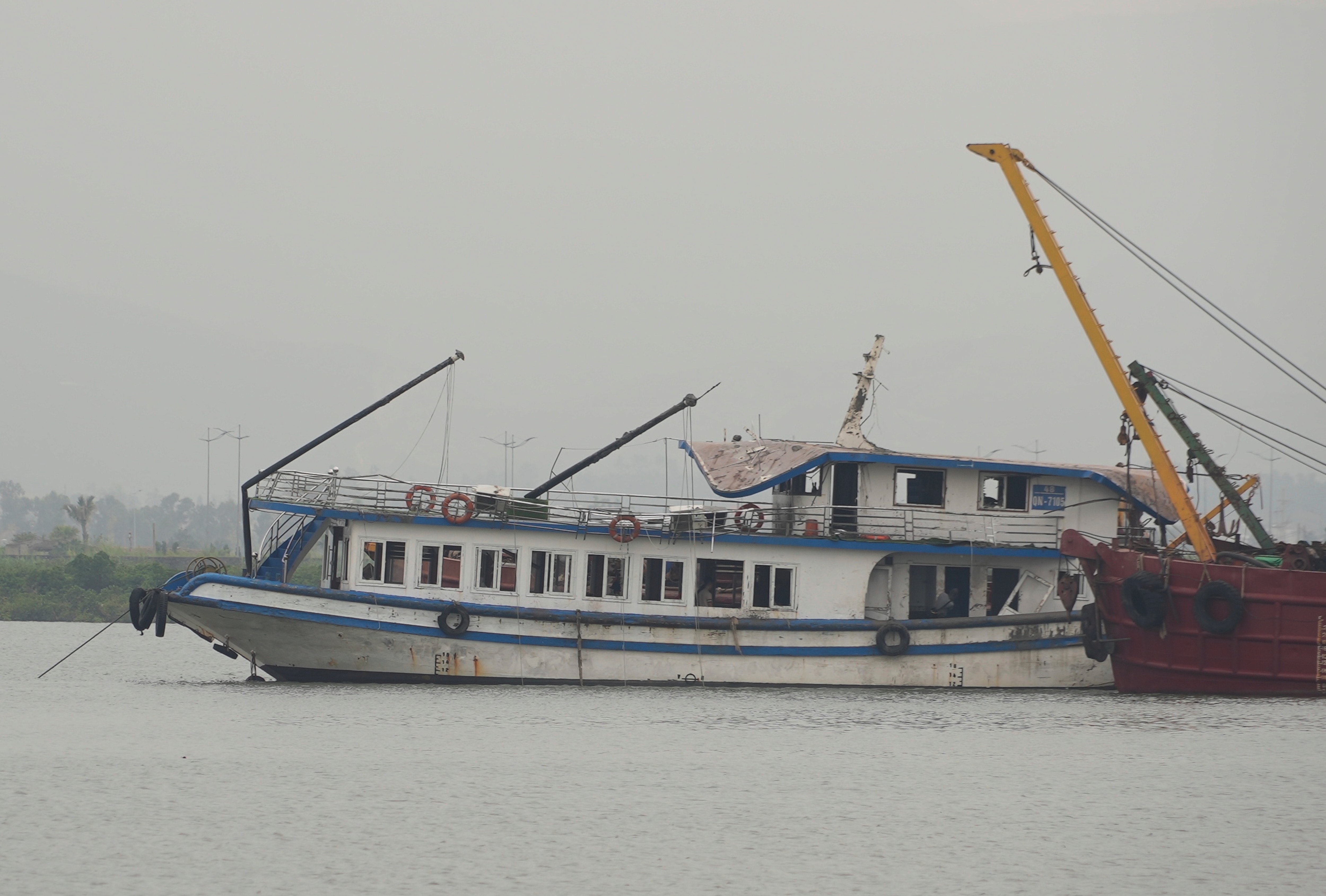 The Wonder Sea tourist boat being towed to a shipyard after capsizing in Ha Long Bay, Vietnam, in July 2025