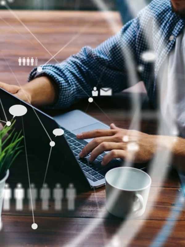 Person using laptop representing Visa payment network's AI-driven workforce reduction