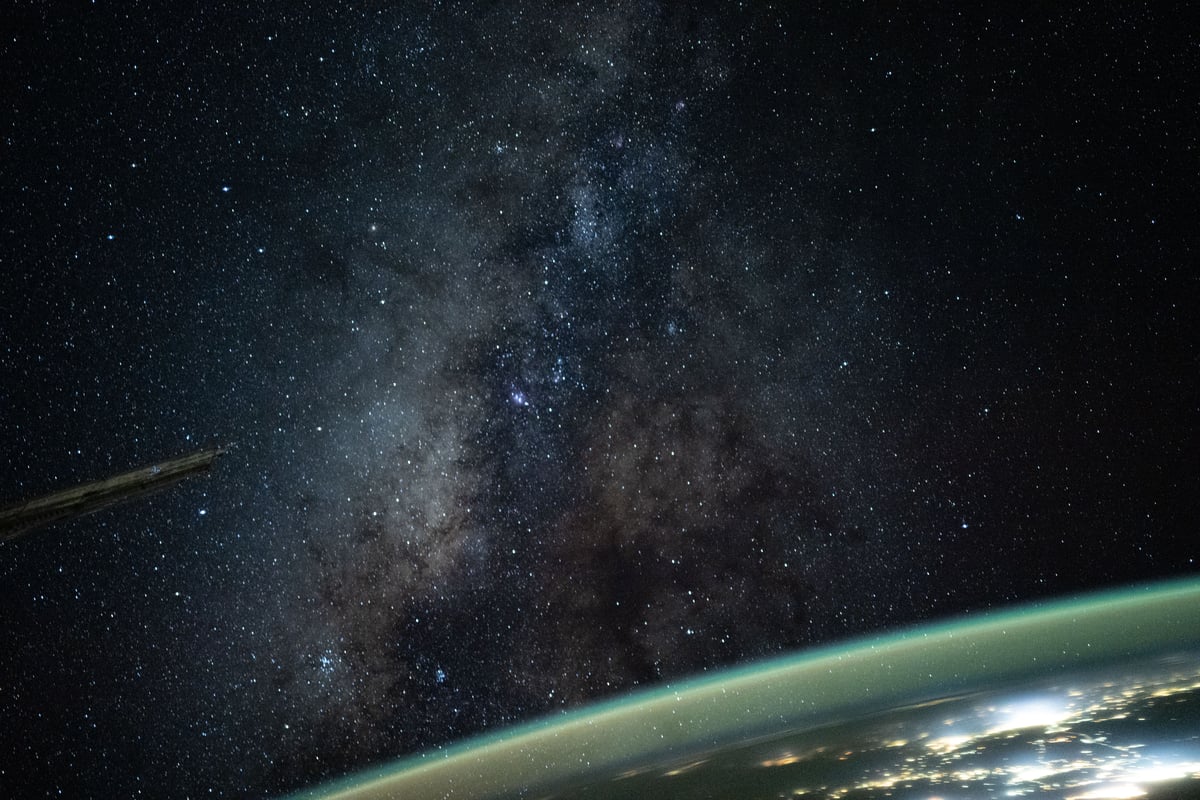 The Milky Way rises above Earth's atmospheric glow in a night sky photograph taken from the International Space Station