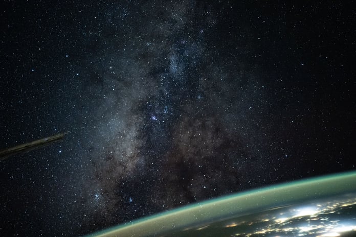 The Milky Way rises above Earth's atmospheric glow in a night sky photograph taken from the International Space Station