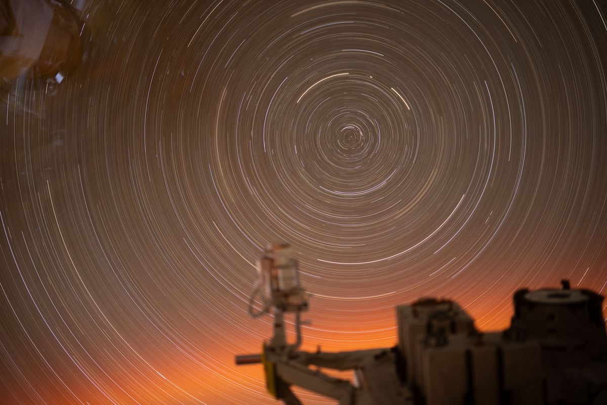 Concentric circular star trails traced over 31 minutes in a long exposure photograph taken from the International Space Station