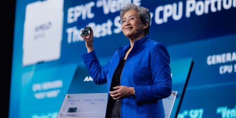 AMD stock today: chair and chief executive Lisa Su holds a processor on stage at the AMD Advancing AI keynote in July 2026