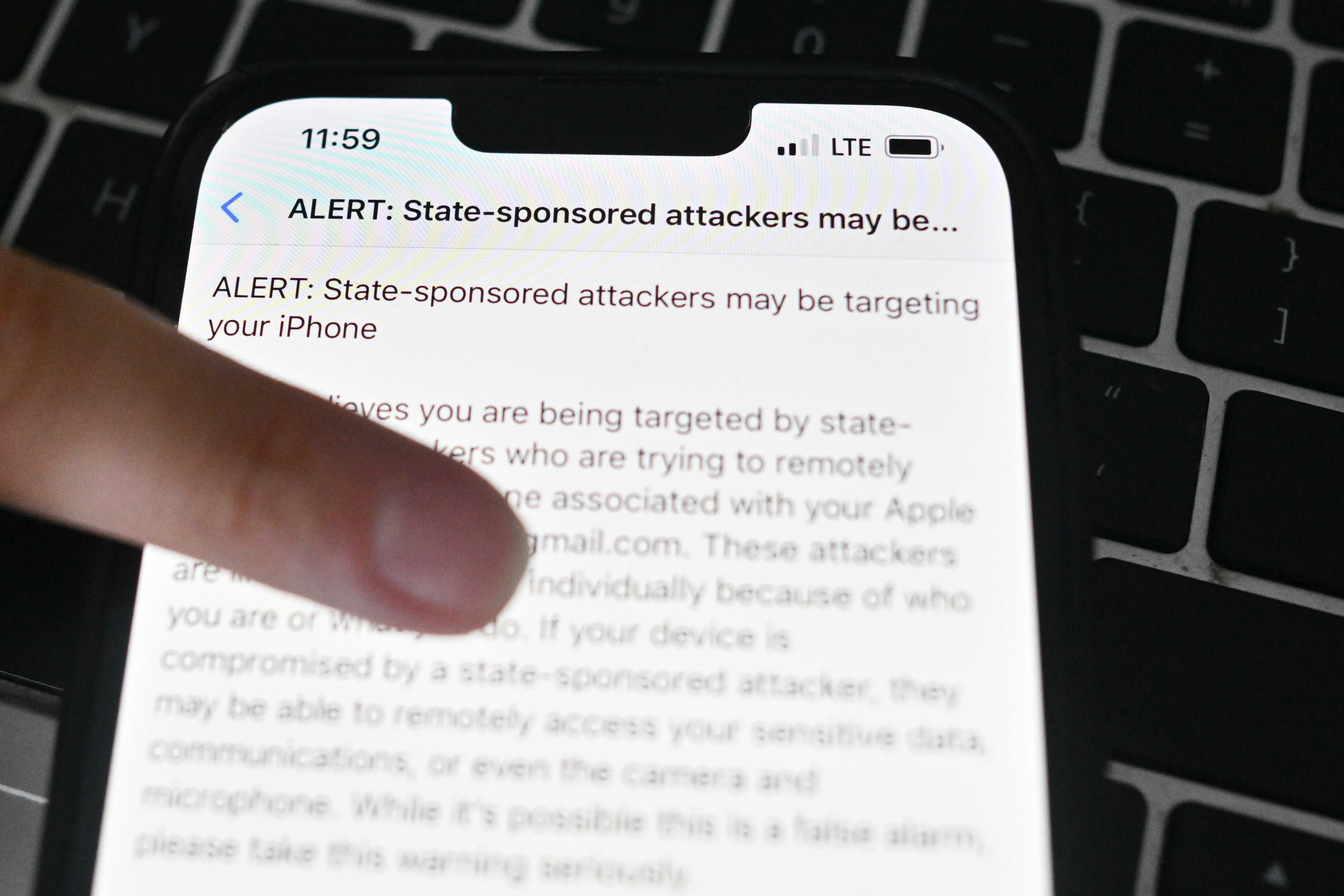 iPhone screen showing Apple security alert about potential state-sponsored spyware attack
