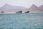 Boats transit the Bab al-Mandeb Strait near Yemen the critical Red Sea shipping chokepoint targeted in the Houthi toll dispute