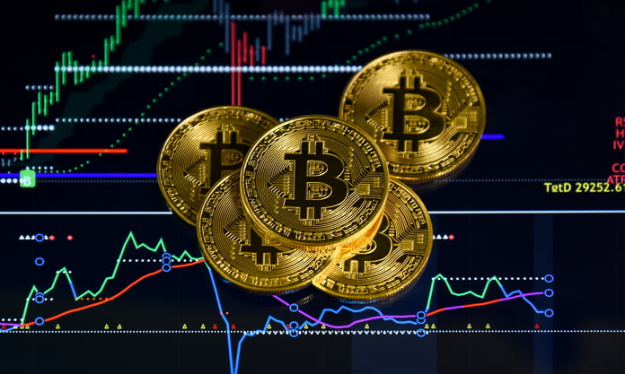 Bitcoin coins photographed as spot ETF inflows push BTC price above $80,000 in August 2026