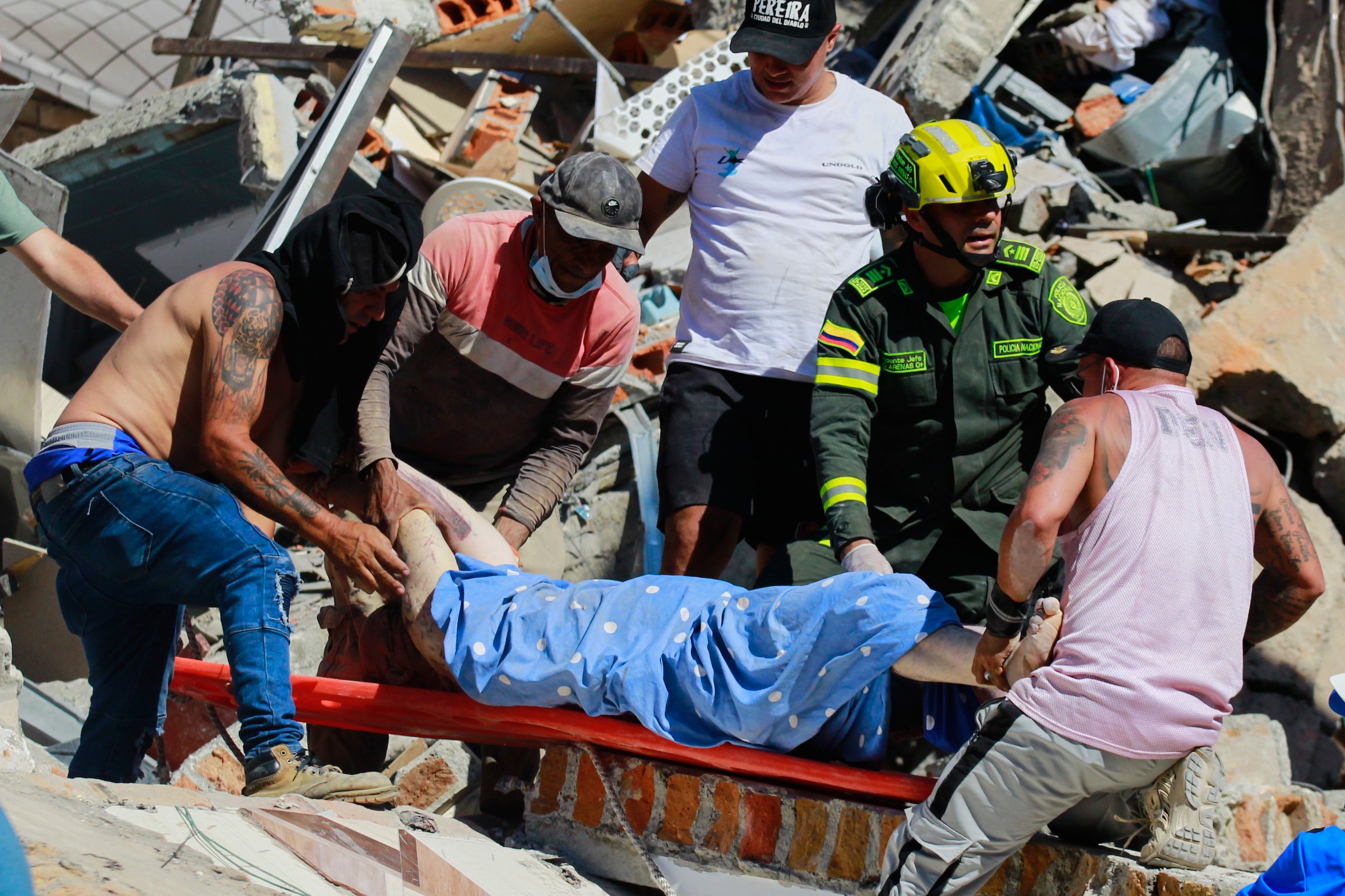 Rescue workers carry a survivor pulled from rubble in Pereira after the Colombia 7.4 earthquake August 2026
