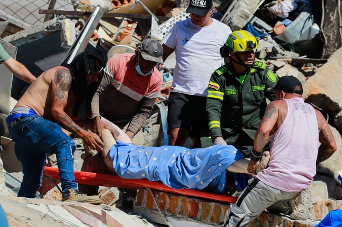 Rescue workers carry a survivor pulled from rubble in Pereira after the Colombia 7.4 earthquake August 2026