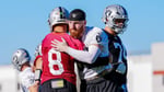 Kirk Cousins charging at Maxx Crosby during Las Vegas Raiders training camp practice