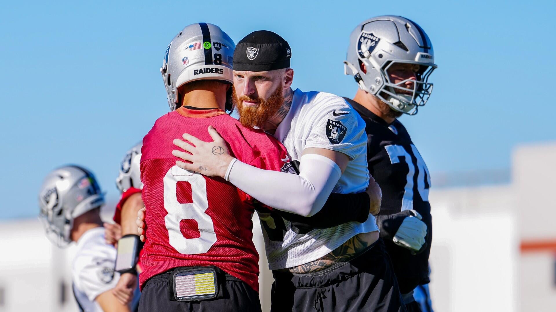 Kirk Cousins charging at Maxx Crosby during Las Vegas Raiders training camp practice