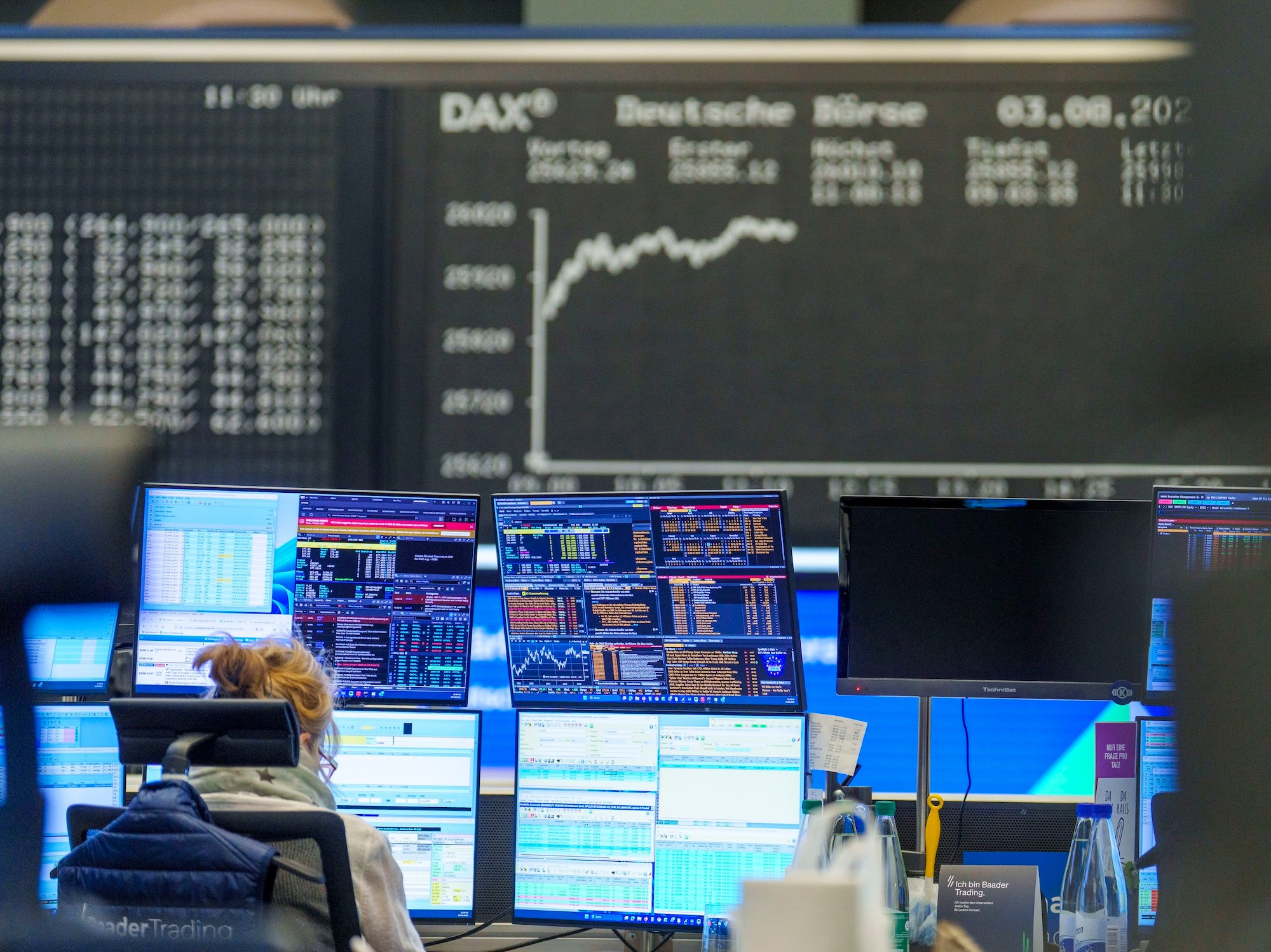 Female trader at Frankfurt stock exchange trading desk as Germany's DAX index reaches record high of 26,000 points on August 3 2026