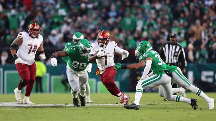 Deebo Samuel running with the ball in Commanders colors during his 2025 season before returning to the San Francisco 49ers