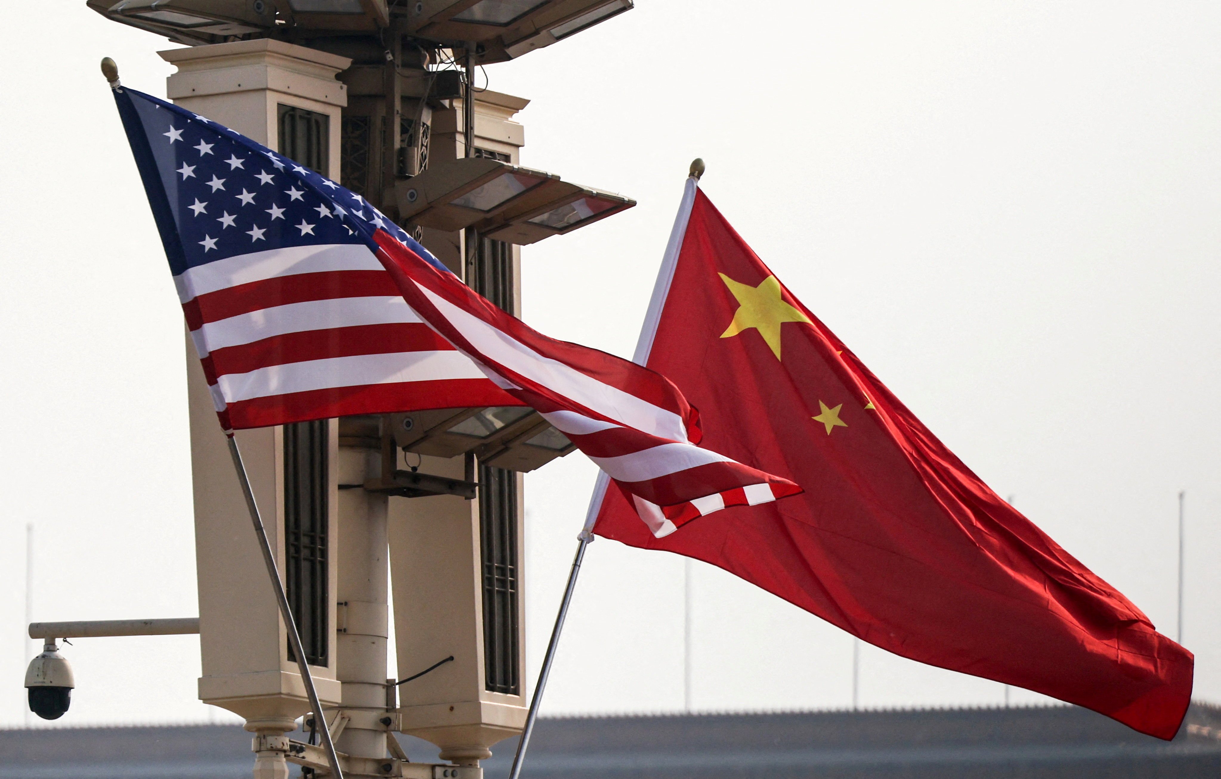 Dow Jones today: United States and Chinese national flags in Beijing as Washington expands sanctions on Iranian oil and Beijing says it will safeguard its own interests