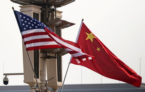Dow Jones today: United States and Chinese national flags in Beijing as Washington expands sanctions on Iranian oil and Beijing says it will safeguard its own interests