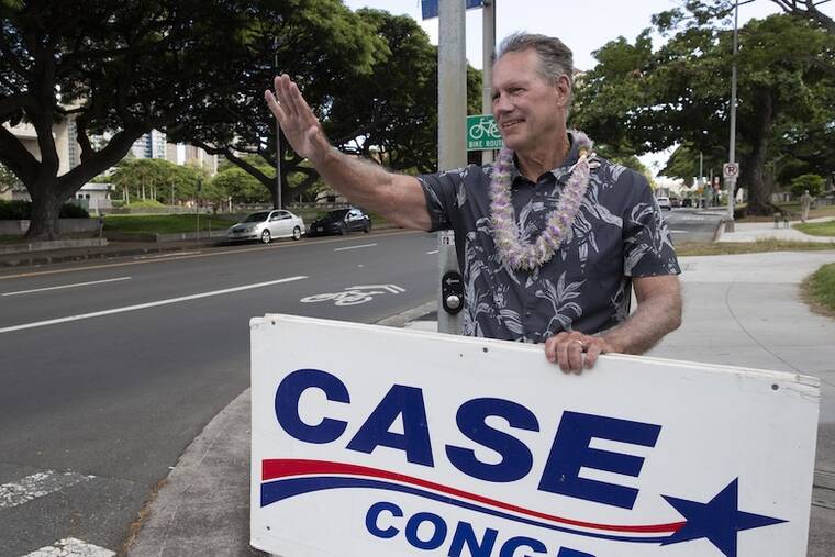 U.S. Rep. Ed Case waving campaign signs at Punchbowl and Beretania streets in Honolulu on August 8 2026 primary day