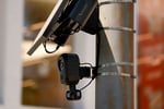 A Flock Safety automated license plate reader camera mounted on a roadside pole