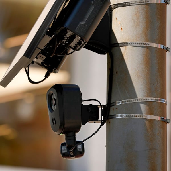 A Flock Safety automated license plate reader camera mounted on a roadside pole